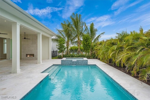 view of pool featuring ceiling fan, a patio, and an in ground hot tub