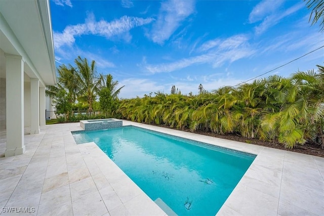 view of pool featuring an in ground hot tub and a patio