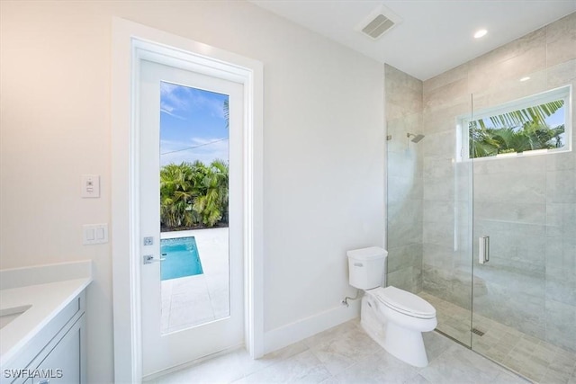 bathroom with a shower with shower door, toilet, and vanity