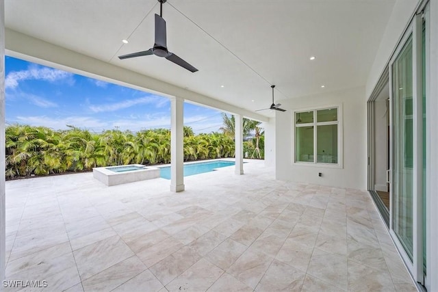 view of patio featuring ceiling fan and a pool with hot tub