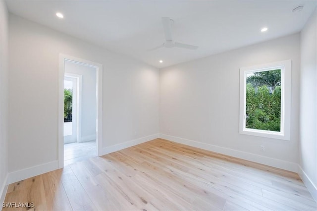 spare room featuring ceiling fan and light hardwood / wood-style flooring