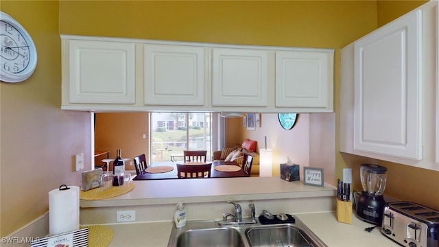 kitchen featuring white cabinetry and sink