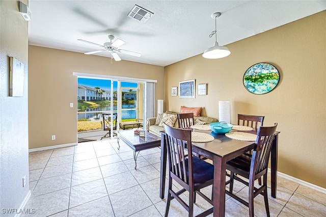 dining space featuring visible vents, ceiling fan, baseboards, and light tile patterned floors