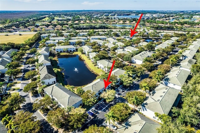 birds eye view of property with a water view and a residential view