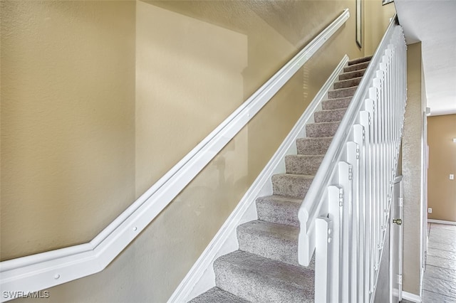 stairs featuring baseboards