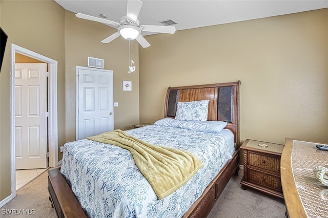 carpeted bedroom with vaulted ceiling, visible vents, and ceiling fan