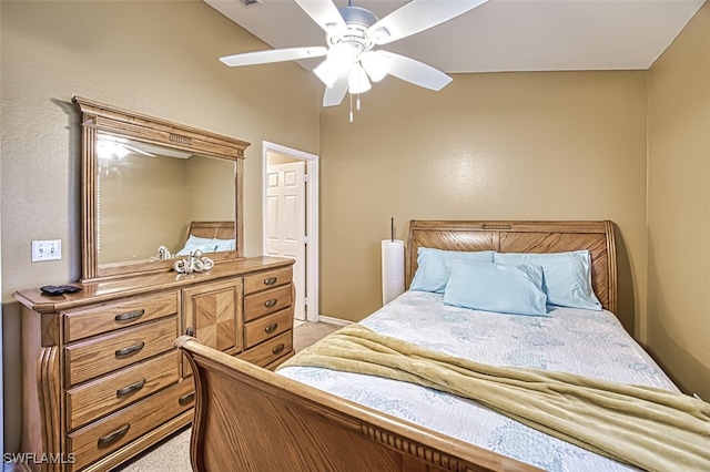 bedroom with a ceiling fan, light colored carpet, and baseboards