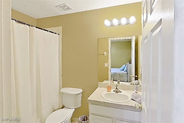 bathroom featuring toilet, vanity, ensuite bath, and visible vents