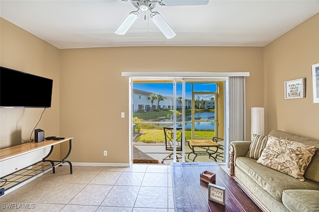 living room with ceiling fan, tile patterned flooring, and baseboards