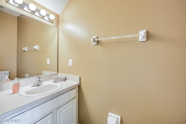 half bathroom featuring toilet and vanity