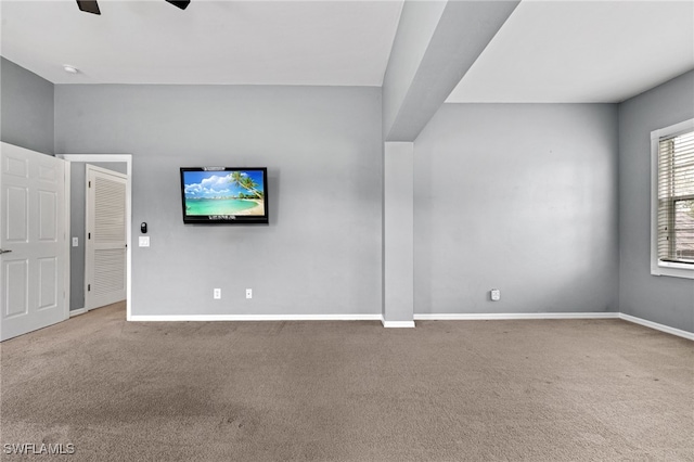 unfurnished living room featuring carpet floors and ceiling fan