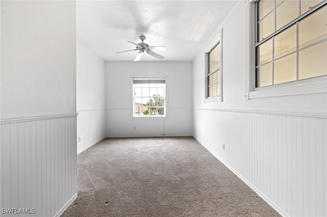 carpeted empty room featuring ceiling fan