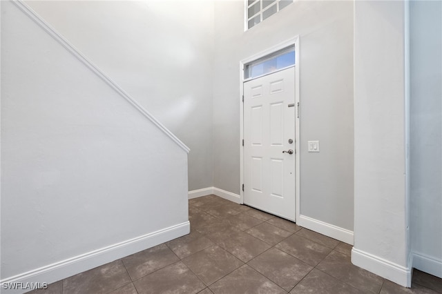 entrance foyer with dark tile patterned flooring