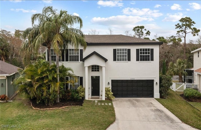 view of front of home featuring a garage and a front lawn