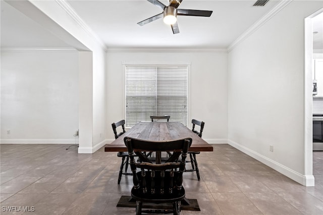 tiled dining space featuring crown molding and ceiling fan