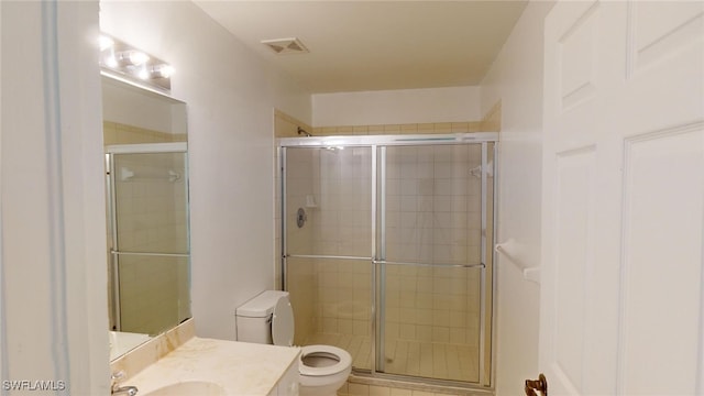 bathroom with walk in shower, vanity, and toilet