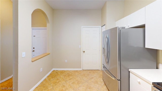 kitchen featuring white cabinetry, light tile patterned flooring, and appliances with stainless steel finishes