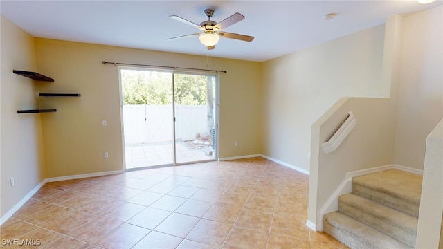 tiled empty room with ceiling fan