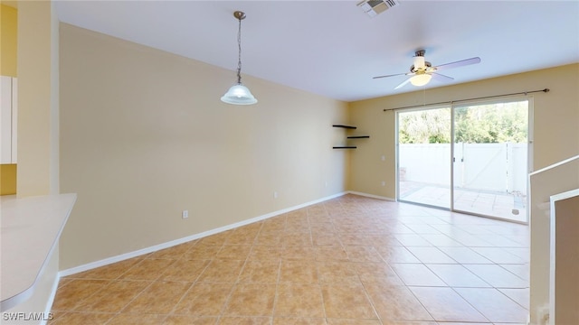 tiled spare room featuring ceiling fan