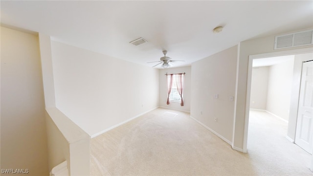 unfurnished room featuring light colored carpet and ceiling fan