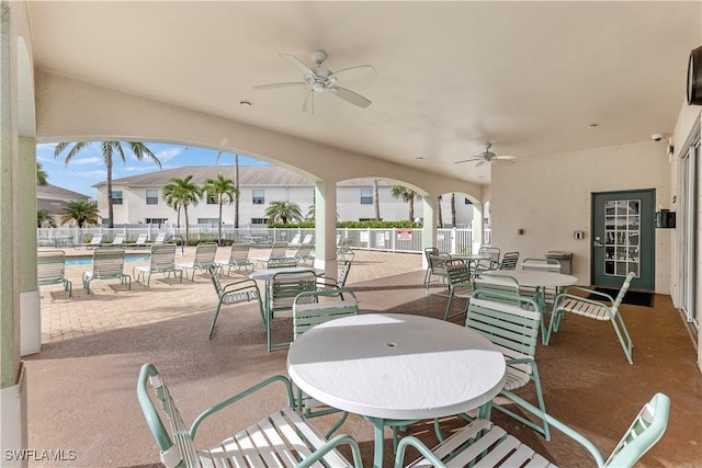 view of patio featuring a community pool and ceiling fan