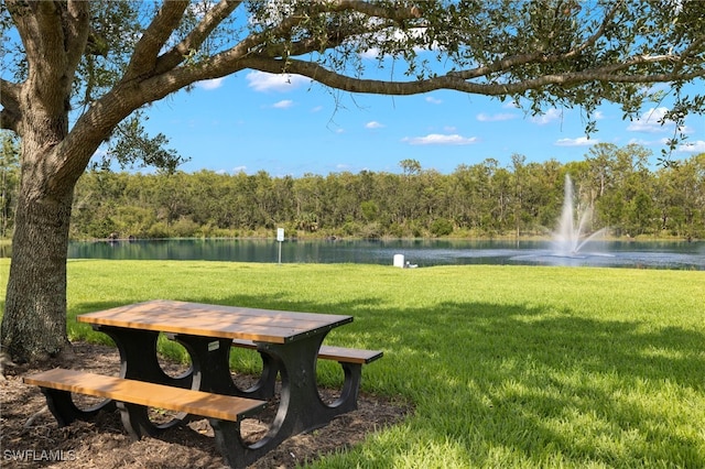 view of home's community featuring a yard and a water view