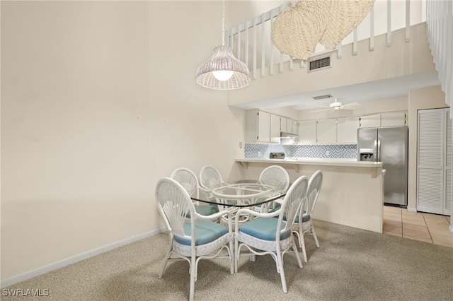 carpeted dining room featuring ceiling fan