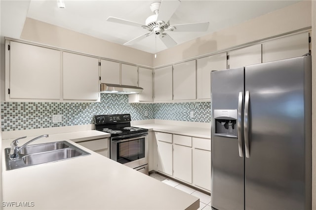 kitchen with white cabinets, appliances with stainless steel finishes, tasteful backsplash, sink, and light tile patterned floors