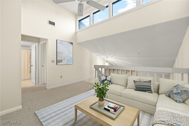 carpeted living room with a towering ceiling