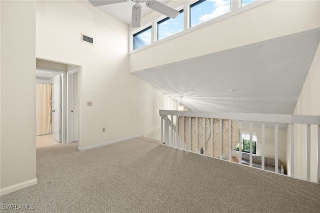 interior space with a high ceiling and carpet floors