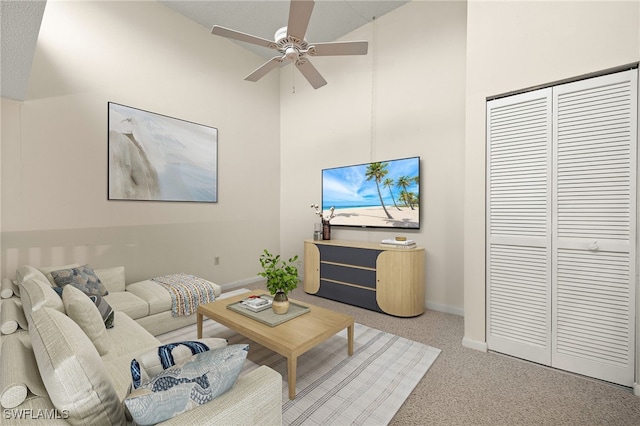 carpeted living room with vaulted ceiling and ceiling fan