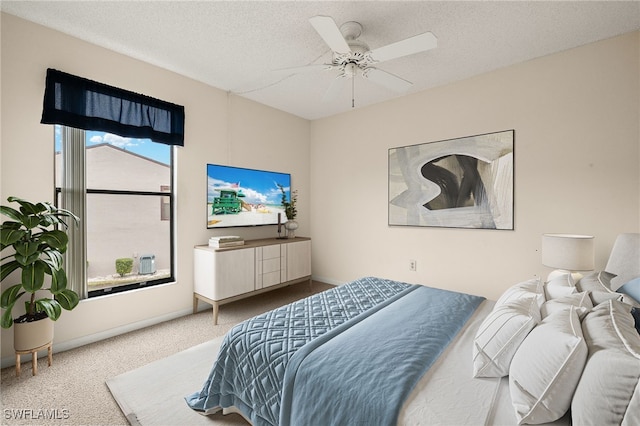 carpeted bedroom featuring a textured ceiling and ceiling fan