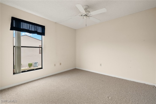 carpeted spare room with a textured ceiling and ceiling fan