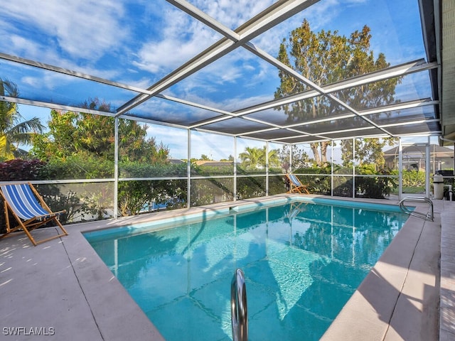 view of pool with glass enclosure