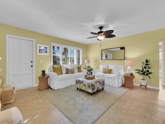 tiled living room featuring ceiling fan and a textured ceiling