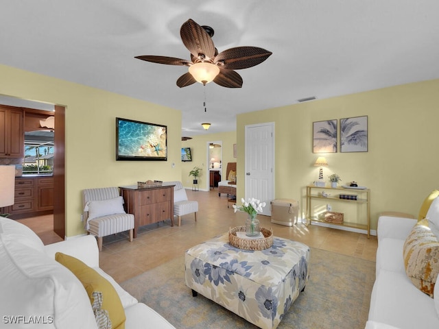 tiled living room featuring ceiling fan