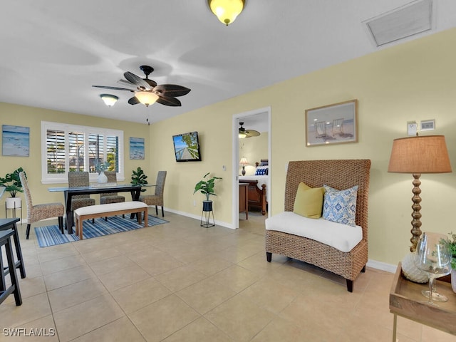 living area with light tile patterned flooring and ceiling fan