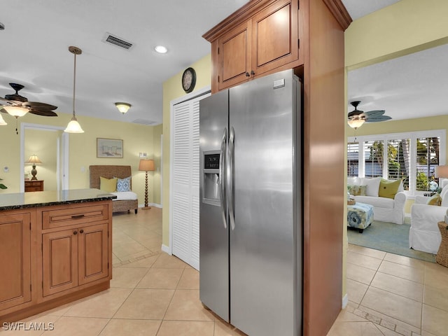 kitchen featuring stainless steel refrigerator with ice dispenser, decorative light fixtures, light tile patterned floors, and ceiling fan