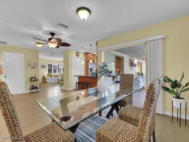 dining area with ceiling fan and light tile patterned flooring