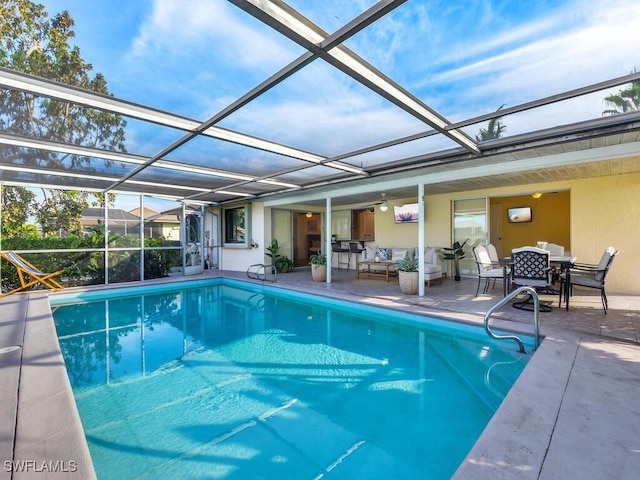 view of swimming pool with glass enclosure, an outdoor living space, and a patio