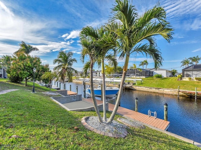 dock area featuring a water view and a yard