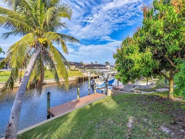 dock area with a water view and a lawn