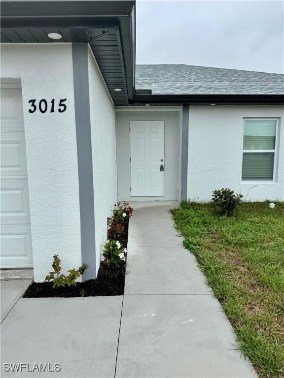 doorway to property with a garage