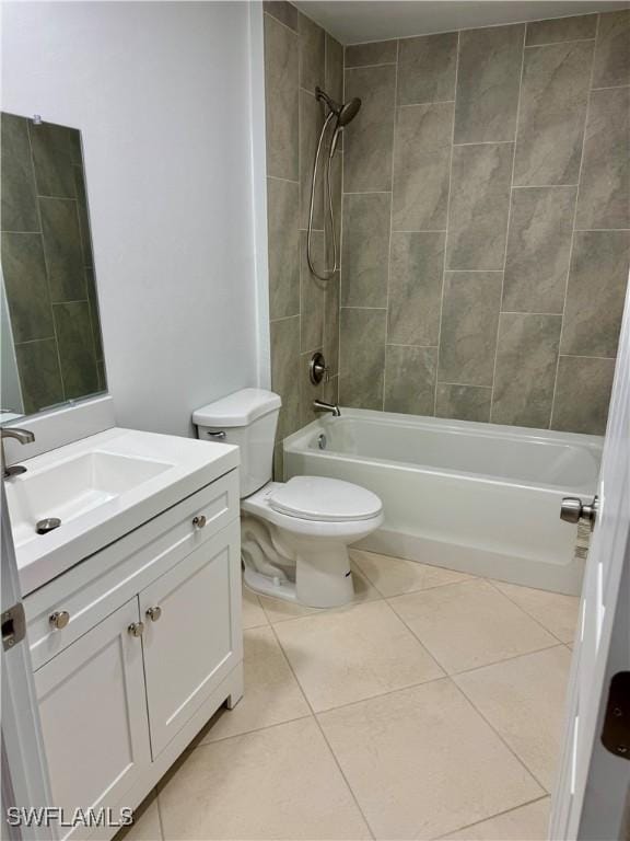 full bathroom with tiled shower / bath combo, vanity, toilet, and tile patterned flooring