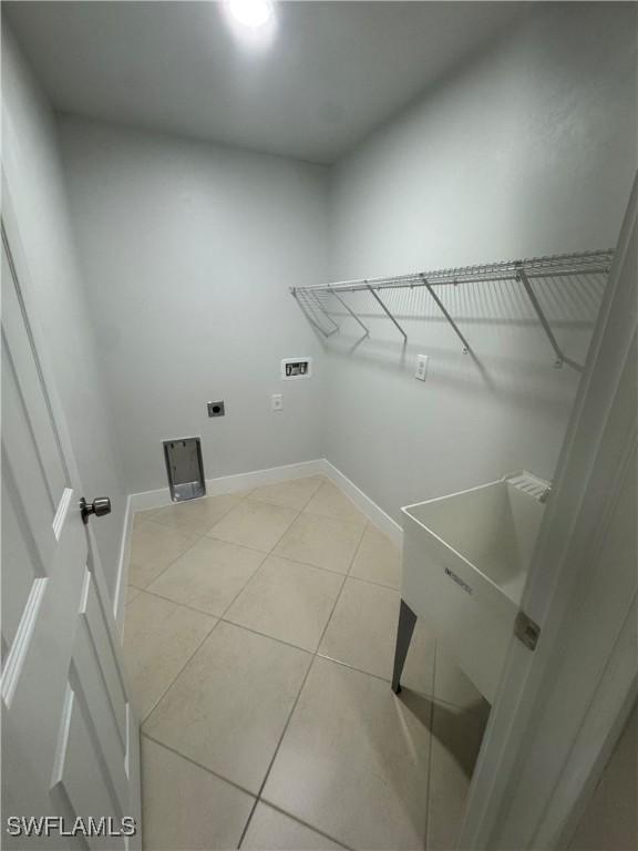 laundry room featuring light tile patterned flooring, washer hookup, and electric dryer hookup