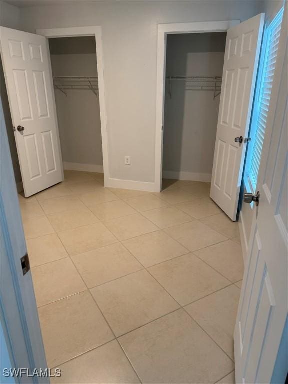 unfurnished bedroom with light tile patterned floors