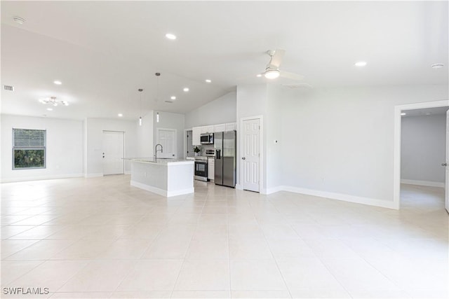 unfurnished living room featuring light tile patterned flooring, ceiling fan, lofted ceiling, and sink