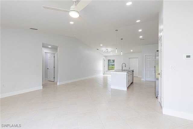 interior space with vaulted ceiling, ceiling fan, and sink