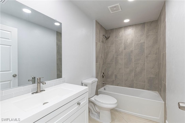 full bathroom with vanity, tile patterned floors, toilet, and tiled shower / bath