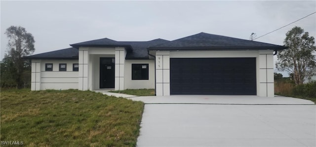 view of front of property featuring a garage and a front lawn